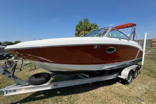 Slide: The Image of 2008 Chaparral Sunesta 224 boat on trailer, red and white design, parked on grass. - 6