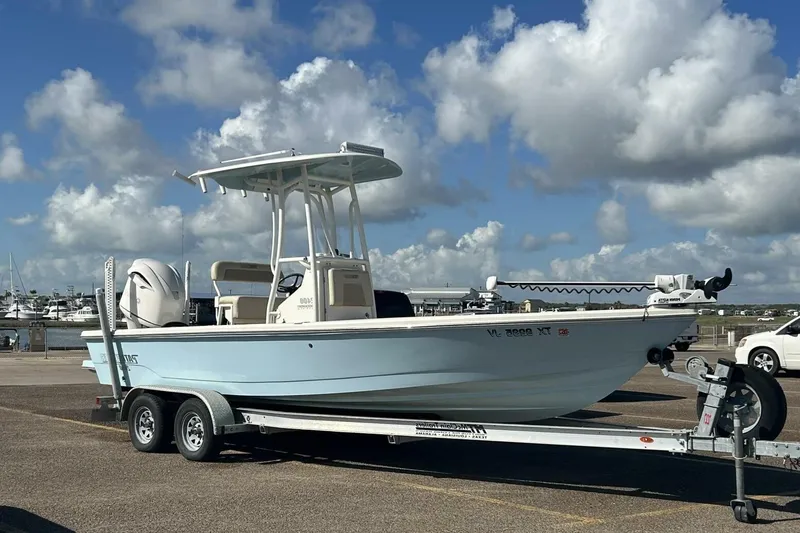 Slide: The Image of 2021 Pathfinder 2400 TRS boat on trailer under cloudy sky at marina. - 1