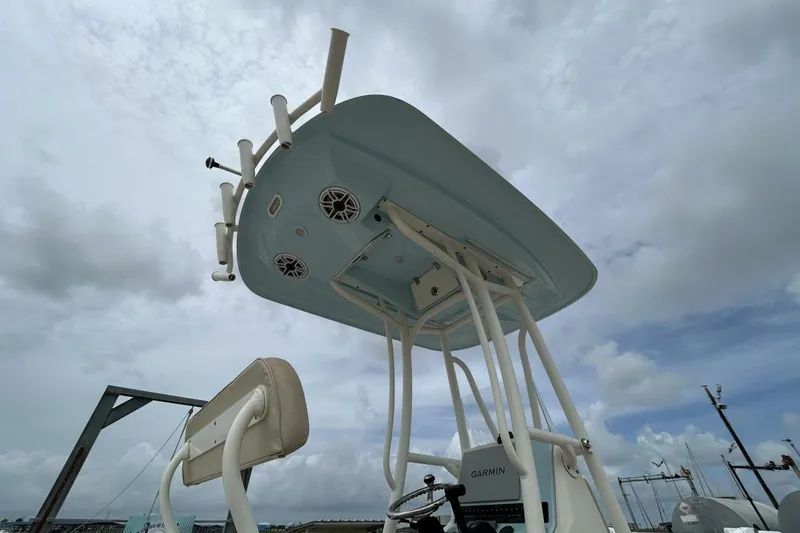 Slide: The Image of 2021 Pathfinder 2400 TRS boat with T-top and speakers under cloudy sky. - 10