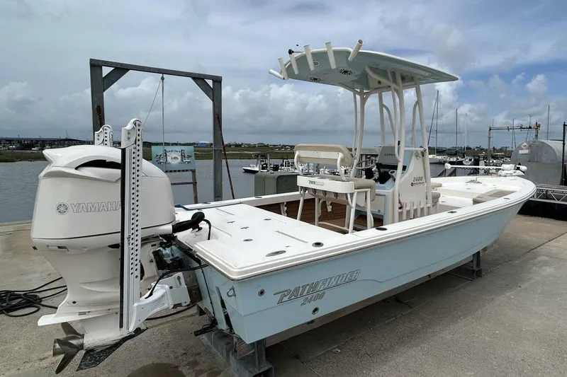 Slide: The Image of 2021 Pathfinder 2400 TRS boat with Yamaha engine docked at marina. - 13