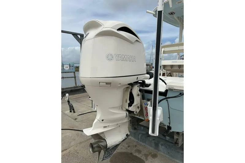 Slide: The Image of Yamaha outboard motor on 2021 Pathfinder 2400 TRS boat, docked with clear sky background. - 14