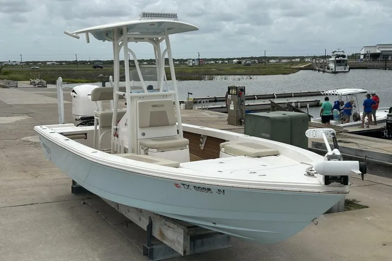 Slide: The Image of 2021 Pathfinder 2400 TRS boat docked at marina, overcast sky, waterfront view. - 2