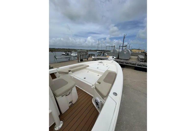 Slide: The Image of 2021 Pathfinder 2400 TRS boat docked, featuring spacious deck and seating. - 4