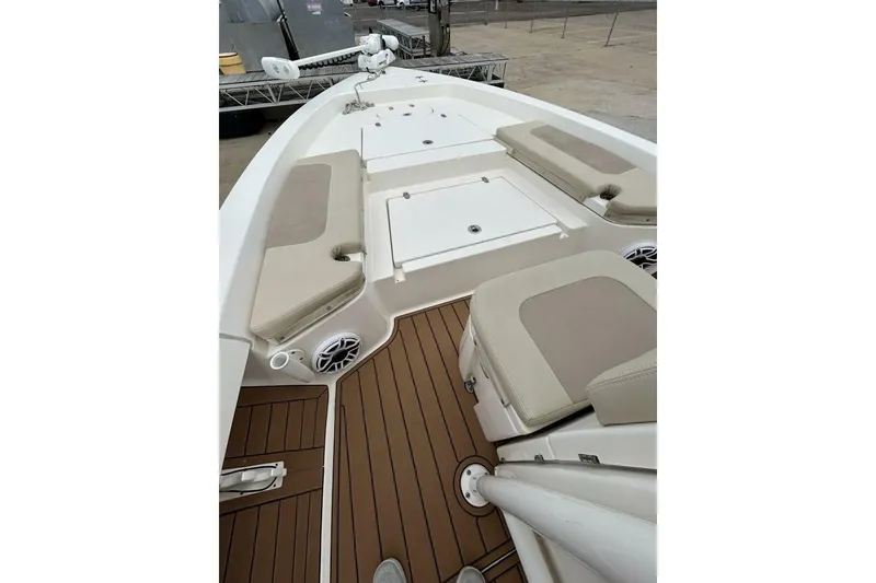 Slide: The Image of 2021 Pathfinder 2400 TRS boat interior with cushioned seating and wood-style flooring. - 5