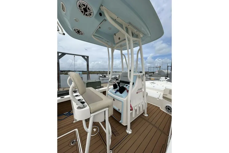Slide: The Image of 2021 Pathfinder 2400 TRS boat interior with helm, seating, and marine speakers. - 7