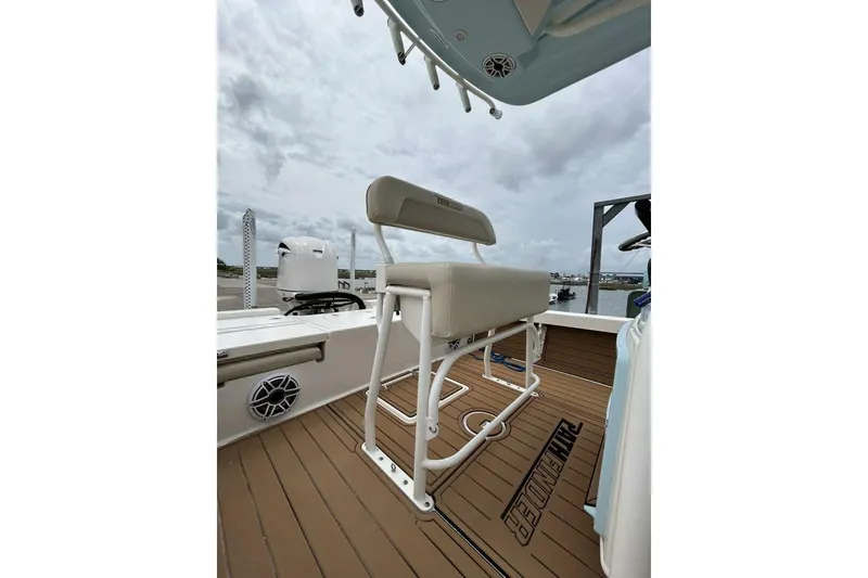 Slide: The Image of 2021 Pathfinder 2400 TRS boat interior with cushioned seating and teak flooring. - 8