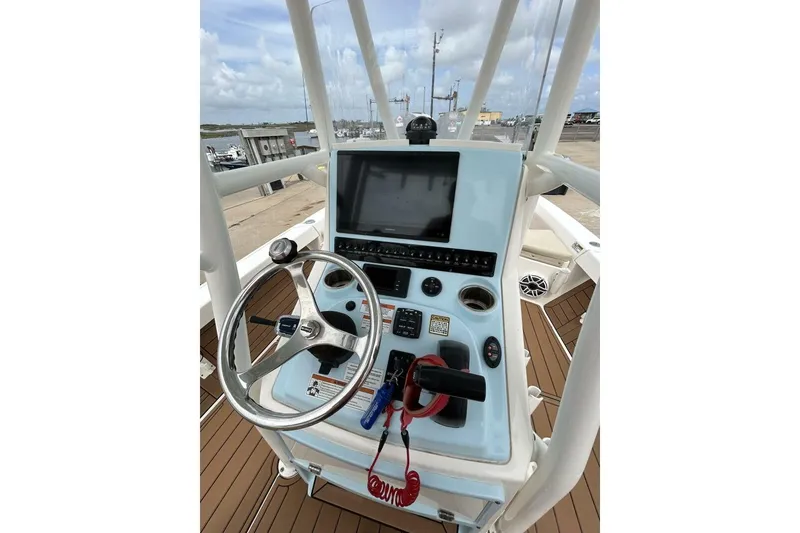 Slide: The Image of 2021 Pathfinder 2400 TRS boat console with steering wheel and navigation controls. - 9