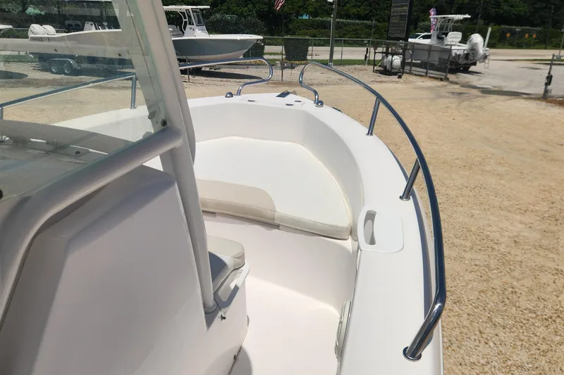 Slide: The Image of 2011 Everglades 230CC boat interior with white seating and stainless steel railings. - 12