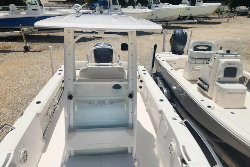 Slide: The Image of 2011 Everglades 230CC boat with center console, parked among other boats. - 13