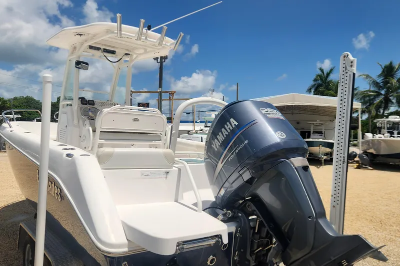 Slide: The Image of 2011 Everglades 230CC boat with Yamaha engine, parked under clear blue sky. - 6