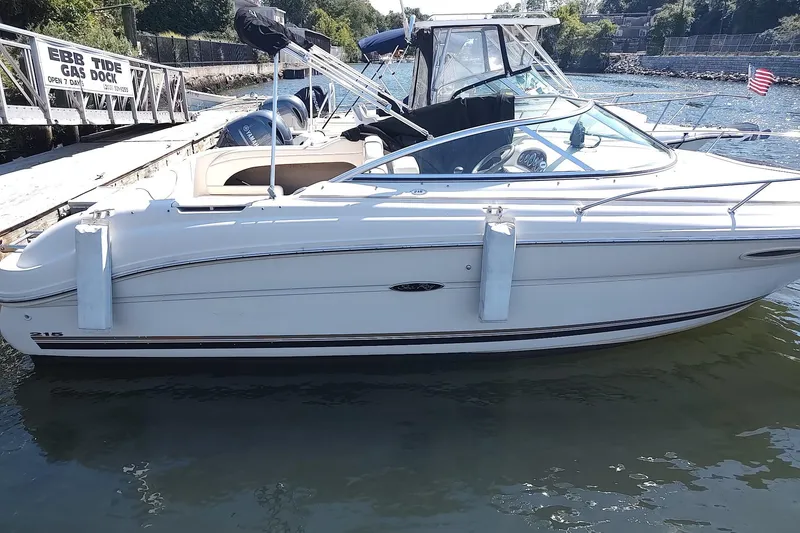 The Image of 2004 Sea Ray 215 Weekender boat docked at marina with clear skies. - 0