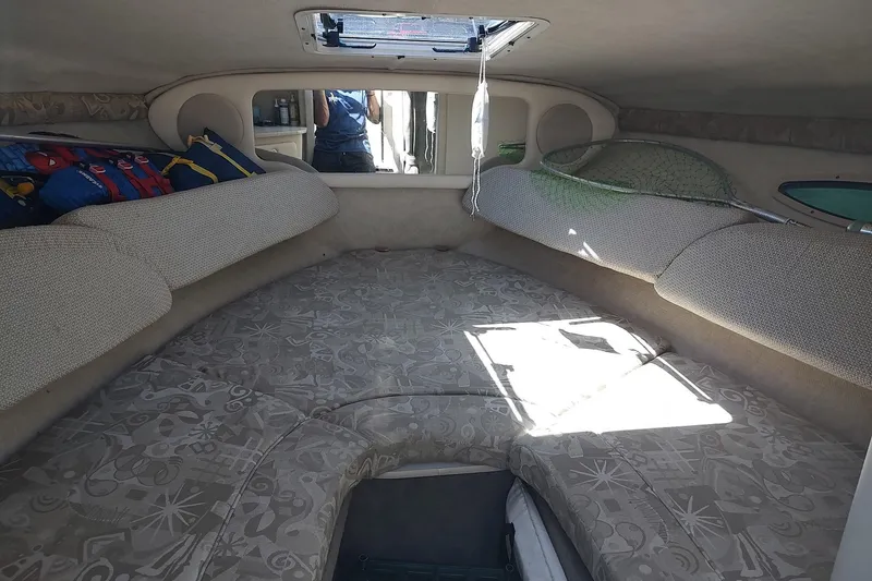 Slide: The Image of Interior cabin of 2004 Sea Ray 215 Weekender boat with cushions and storage. - 12