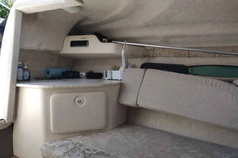 Slide: The Image of Interior cabin of 2004 Sea Ray 215 Weekender boat with seating and storage. - 13