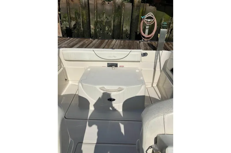 Slide: The Image of 2004 Sea Ray 215 Weekender boat interior with seating and storage area. - 5