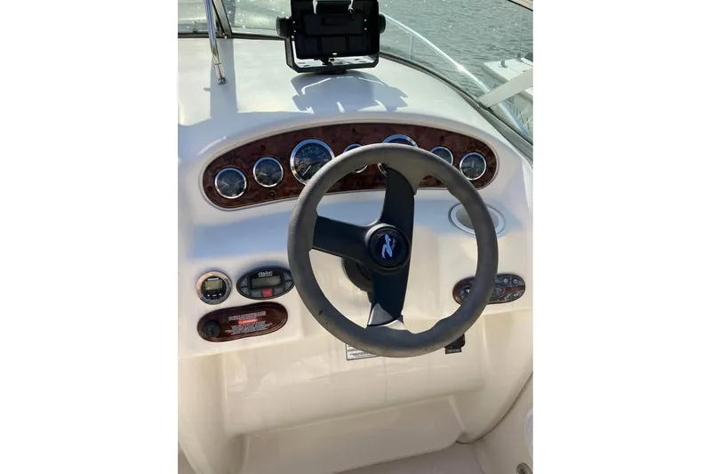 Slide: The Image of Steering console of a 2004 Sea Ray 215 Weekender boat with gauges and controls. - 6