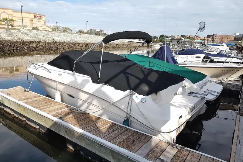 Slide: The Image of 2004 Sea Ray 215 Weekender boat docked at marina with cover. - 9