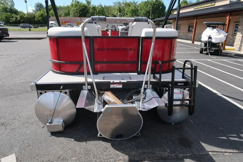 Slide: The Image of 2026 Bennington S Quad Bench 20 SSR pontoon boat, rear view in parking lot. - 10
