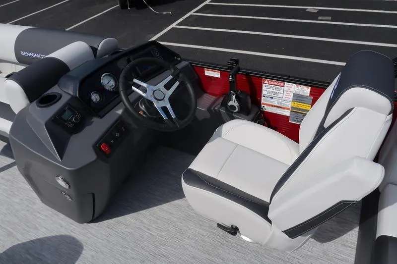Slide: The Image of 2026 Bennington S Quad Bench 20 SSR boat interior with steering wheel and seating. - 19