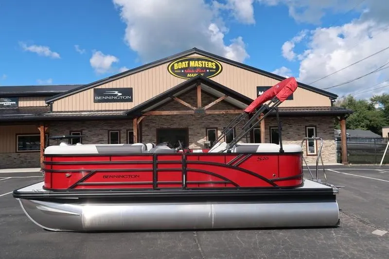 Slide: The Image of 2026 Bennington S Quad Bench 20 SSR pontoon boat in front of dealership. - 4