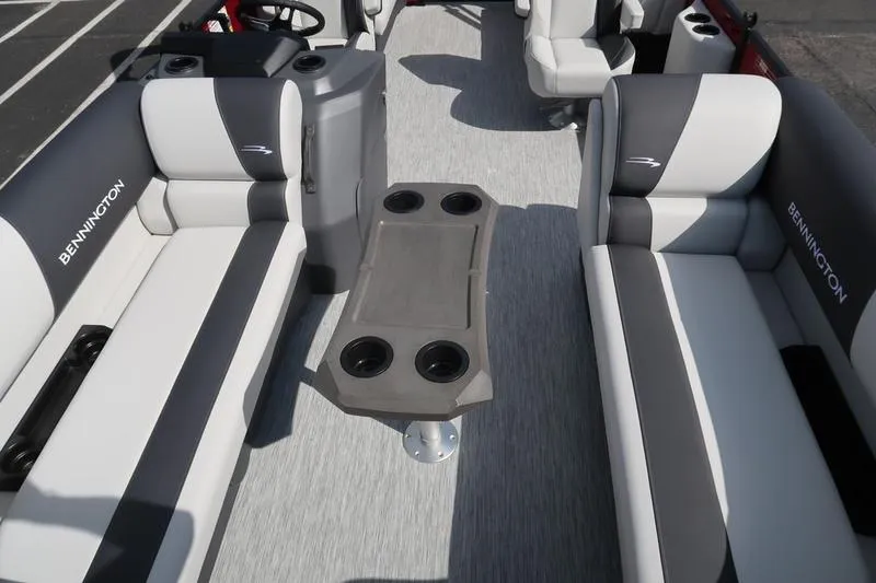 Slide: The Image of 2026 Bennington S Quad Bench 20 SSR interior with gray seating and central table. - 7