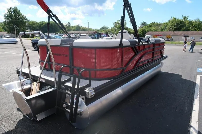 Slide: The Image of 2026 Bennington S Quad Bench 20 SSR pontoon boat in parking lot, rear view. - 8