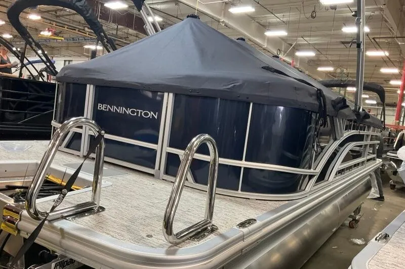 Slide: The Image of 2026 Bennington 22 SSRSE pontoon boat under construction in a factory setting. - 10