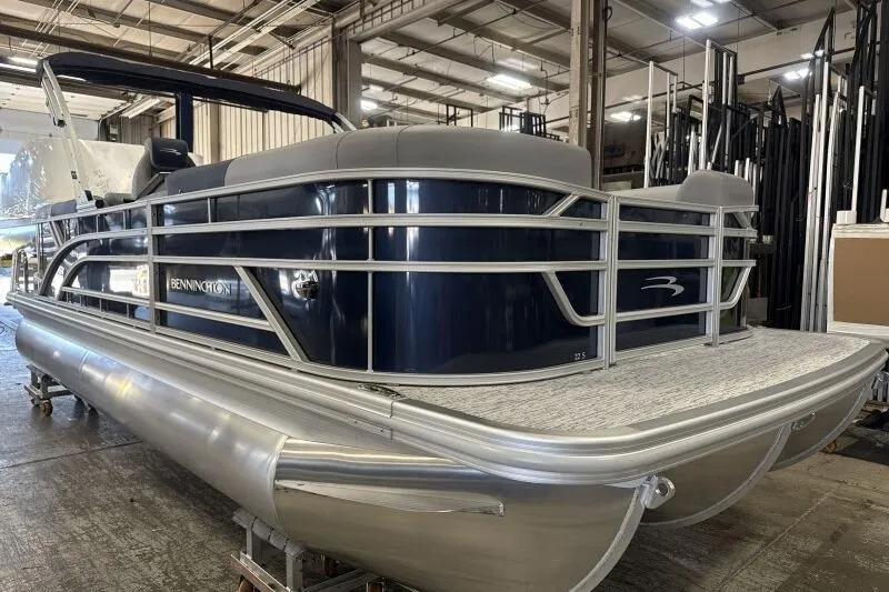 Slide: The Image of 2026 Bennington 22 SSRSE pontoon boat with cover in a warehouse setting. - 11