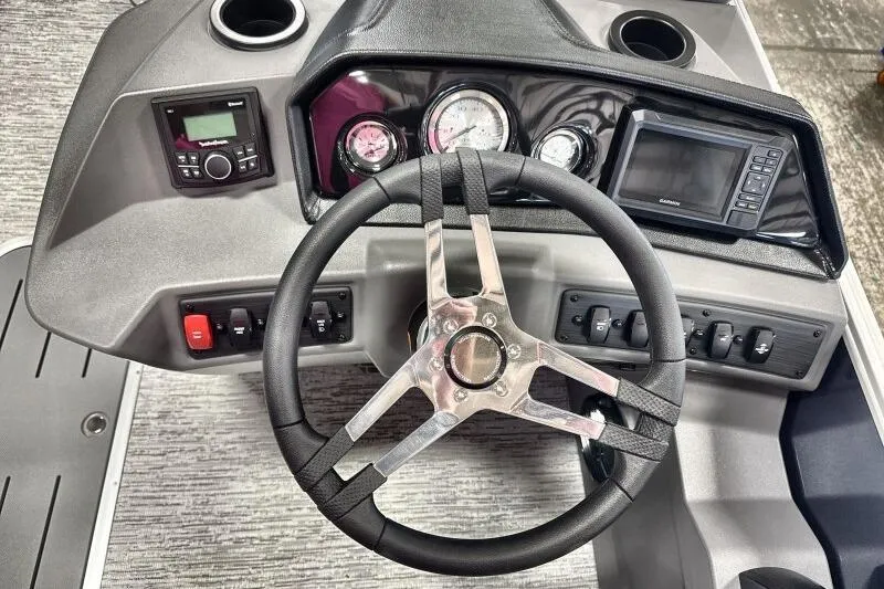 Slide: The Image of 2026 Bennington 22 SSRSE boat dashboard with steering wheel and control panel. - 23