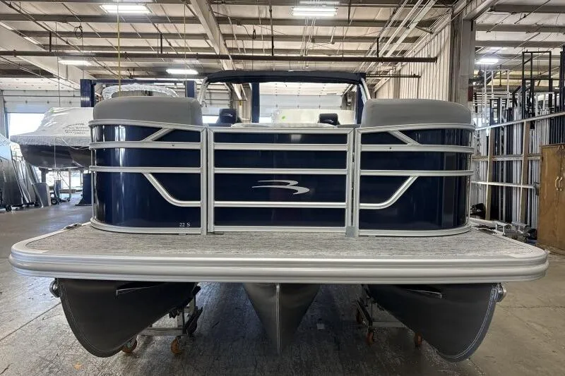 Slide: The Image of 2026 Bennington 22 SSRSE pontoon boat in a warehouse setting. - 3