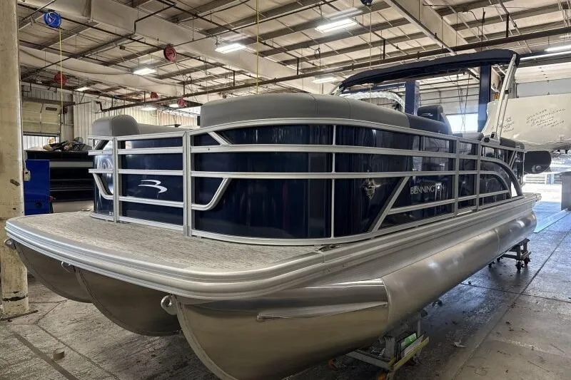 Slide: The Image of 2026 Bennington 22 SSRSE pontoon boat in a spacious indoor facility. - 4
