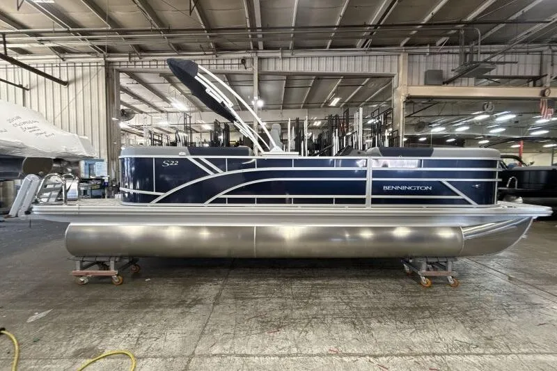 Slide: The Image of 2026 Bennington 22 SSRSE pontoon boat in a warehouse setting. - 8