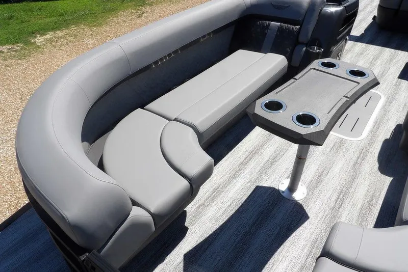 Slide: The Image of 2026 Bennington M Swingback 24 MSB boat interior with gray seating and table. - 11