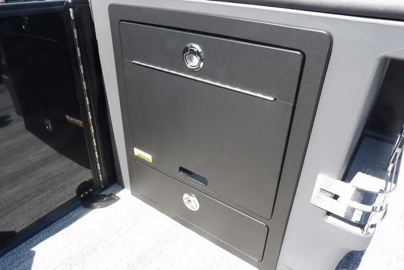 Slide: The Image of 2026 Bennington M Swingback 24 MSB storage compartment with secure locking mechanism. - 18