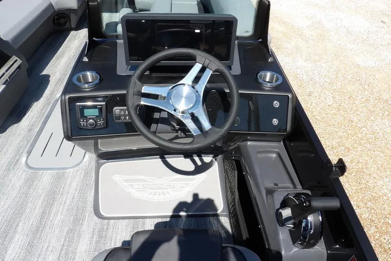 Slide: The Image of 2026 Bennington M Swingback 24 MSB boat dashboard with steering wheel and controls. - 31