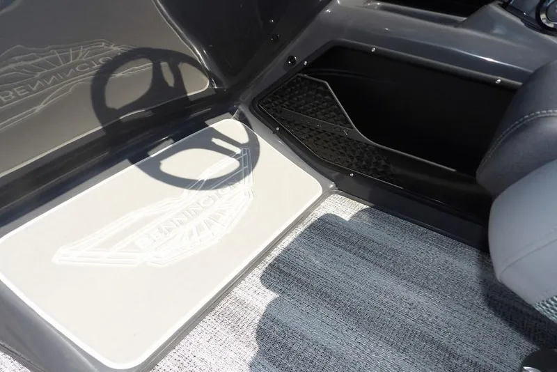 Slide: The Image of Interior of 2026 Bennington M Swingback 24 MSB with steering wheel shadow on floor mat. - 36
