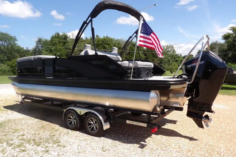 Slide: The Image of 2026 Bennington M Swingback 24 MSB pontoon boat with American flag and Mercury engine. - 5