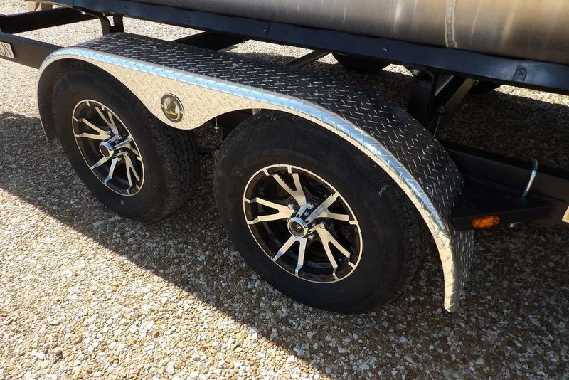 Slide: The Image of Trailer wheels of 2026 Bennington M Swingback 24 MSB with diamond plate fenders. - 53