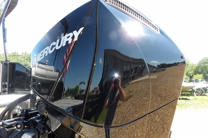 Slide: The Image of 2026 Bennington M Swingback 24 MSB with Mercury engine, reflecting sunlight and surroundings. - 59