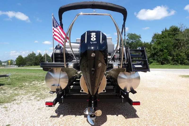 Slide: The Image of 2026 Bennington M Swingback 24 MSB pontoon boat with powerful outboard motor and American flag. - 7