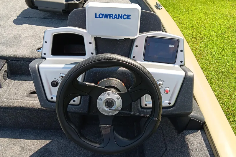 Slide: The Image of 2026 Tracker Pro Team 175 boat dashboard with steering wheel and Lowrance display. - 11