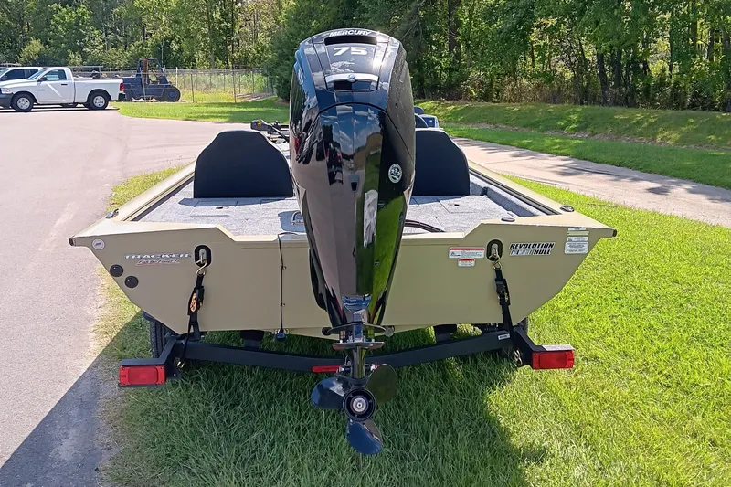Slide: The Image of 2026 Tracker Pro Team 175 boat with Mercury engine, parked on grass. - 6