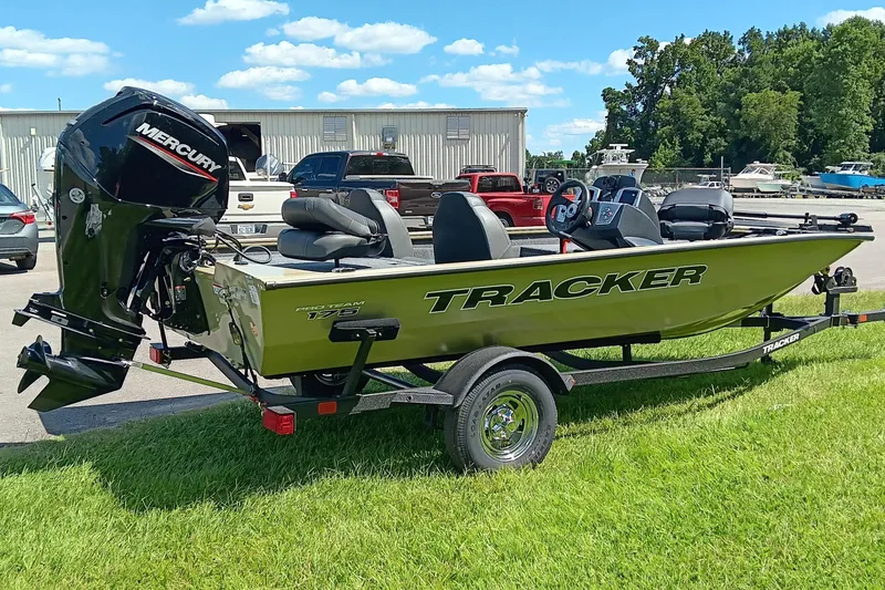 Slide: The Image of 2026 Tracker Pro Team 175 boat with Mercury engine on trailer, parked on grass. - 7