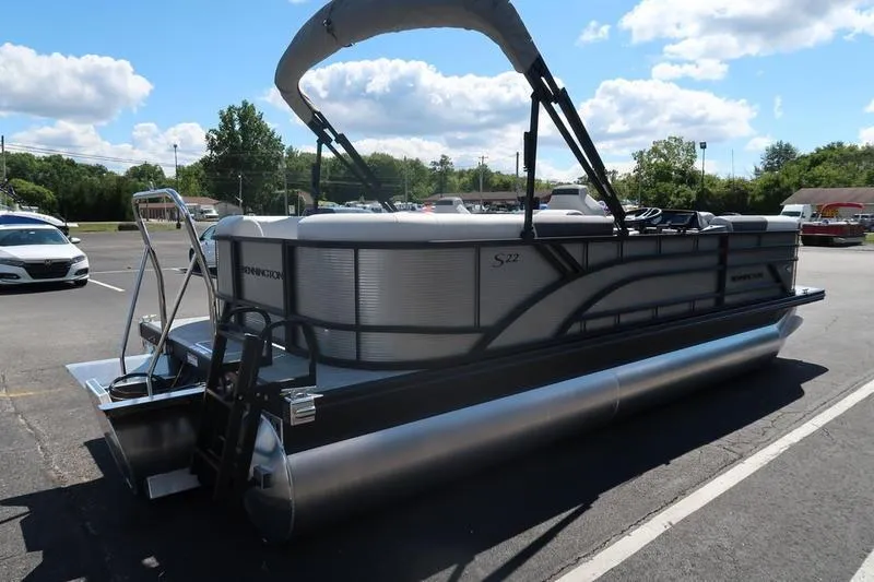 Slide: The Image of 2026 Bennington S Quad Bench 22 SSR pontoon boat parked under a sunny sky. - 10