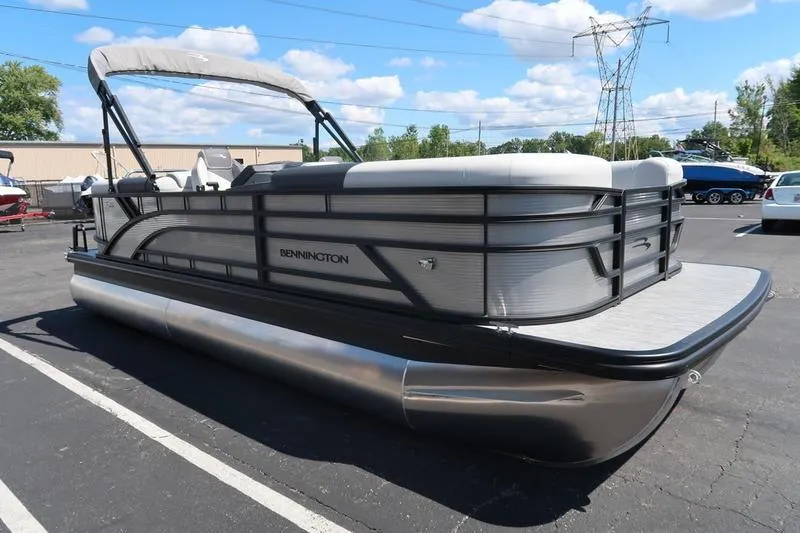 Slide: The Image of 2026 Bennington S Quad Bench 22 SSR pontoon boat in parking lot, sunny day. - 11