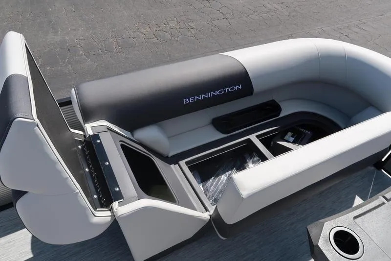 Slide: The Image of 2026 Bennington S Quad Bench 22 SSR with open storage compartments on a boat. - 27