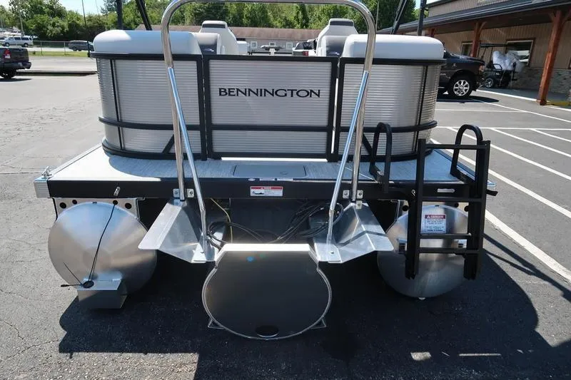 Slide: The Image of 2026 Bennington S Quad Bench 22 SSR pontoon boat, rear view in parking lot. - 3