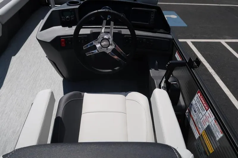 Slide: The Image of 2026 Bennington S Quad Bench 22 SSR boat cockpit with steering wheel and seating. - 30
