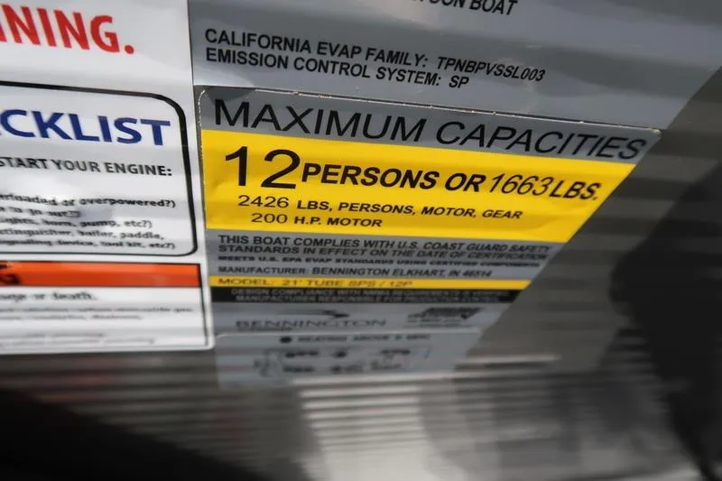 Slide: The Image of Maximum capacity label on 2026 Bennington S Quad Bench 22 SSR boat, 12 persons or 1663 lbs. - 5