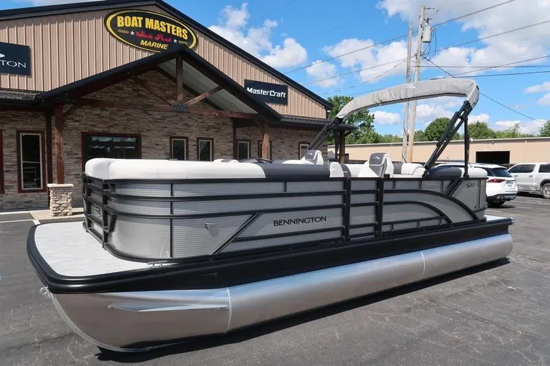 Slide: The Image of 2026 Bennington S Quad Bench 22 SSR pontoon boat at dealership, sunny day. - 7