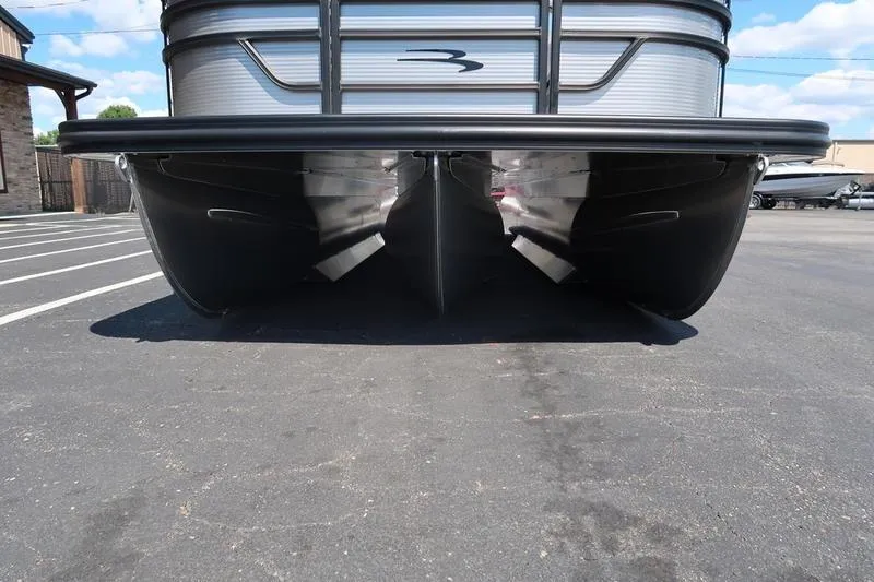 Slide: The Image of 2026 Bennington S Quad Bench 22 SSR pontoon boat, front view on pavement. - 9